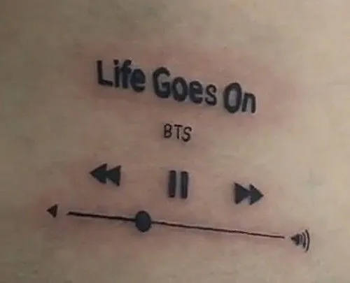 Tatuagem que simula um player de audio tocando "Life Goes On" do BTS